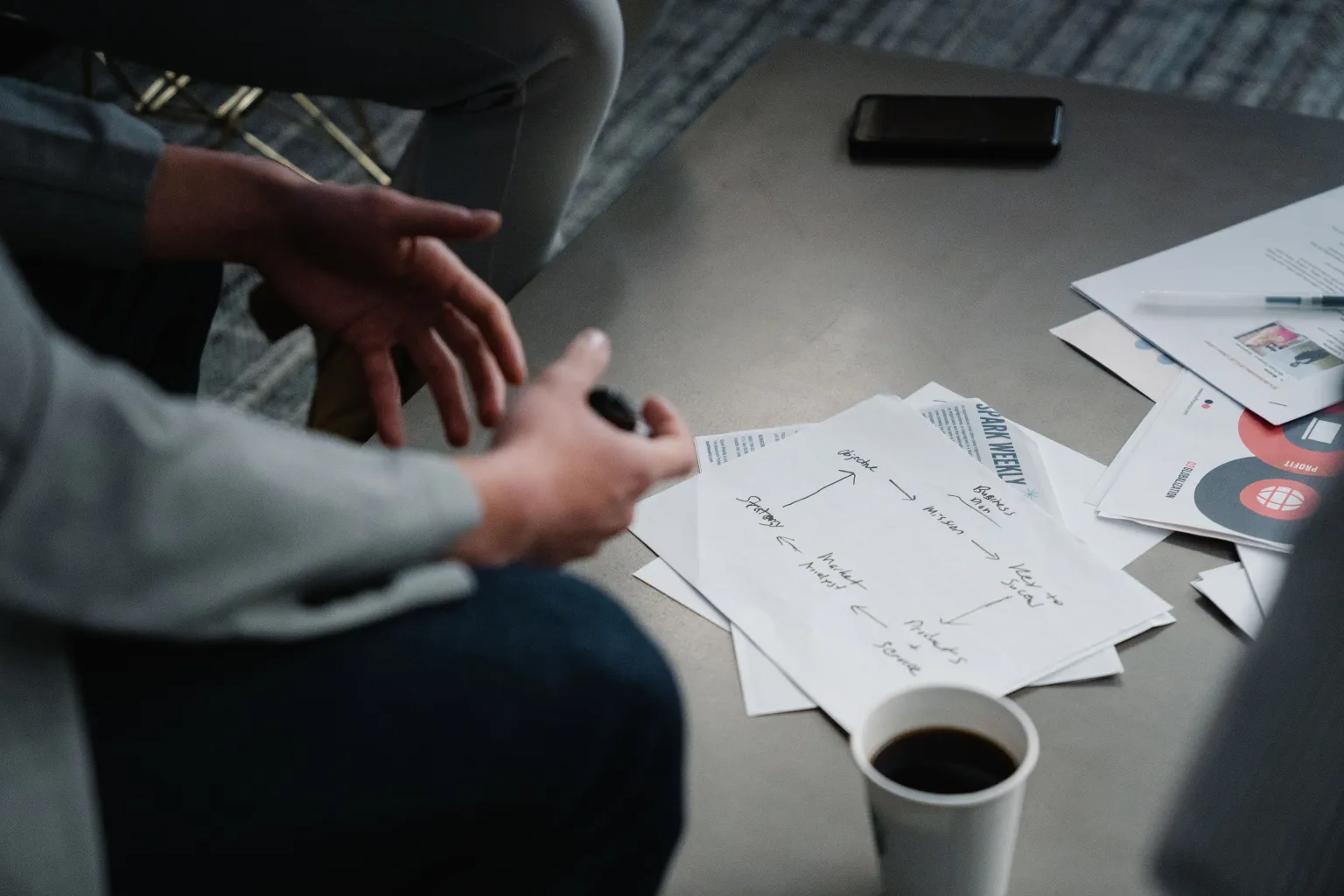 A person annotating documents at a table.